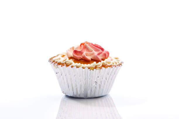 istock An isolated cupcake with sprinkles on a white background 864921890
