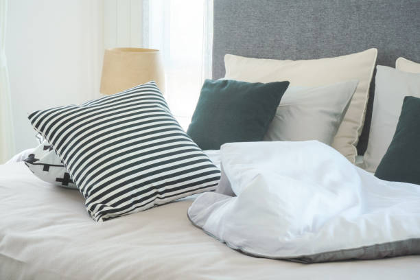 istock Messy bed with pillows in modern interior  bedroom 864922092