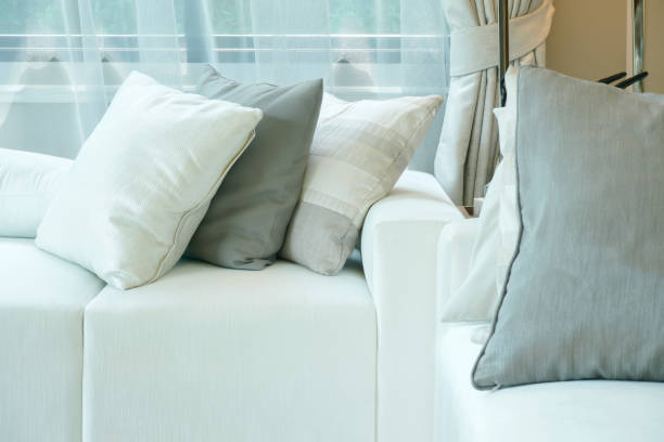 istock White and gray pillows setting on white sofa in living room 864922746