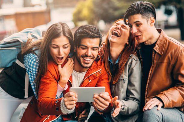 istock Friends using a tablet in the city 864925912