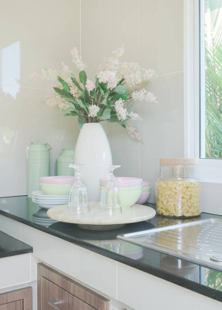 istock Ceramic kitchenware and flower vase on black counter top in the kitchen 864926104