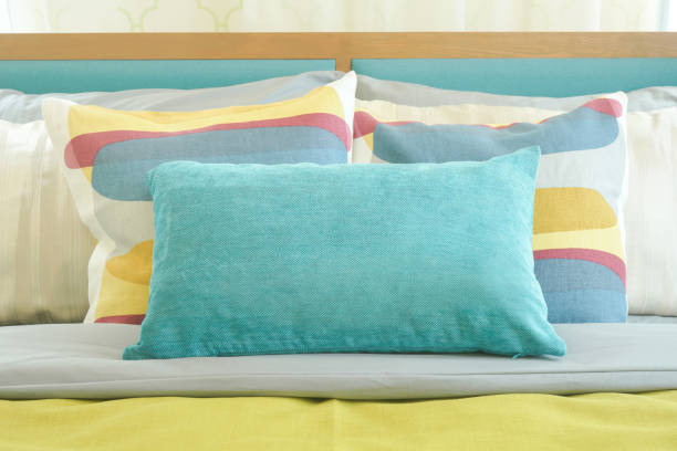 istock Closeup pillows on bed, yellow and green color scheme bedding 864926282