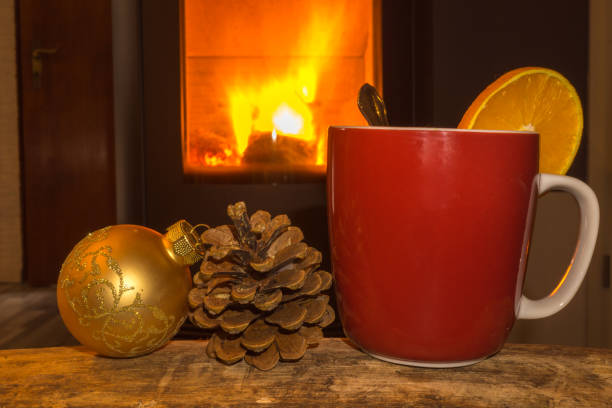 istock one red mug with christmas balls and fireplace 864926336