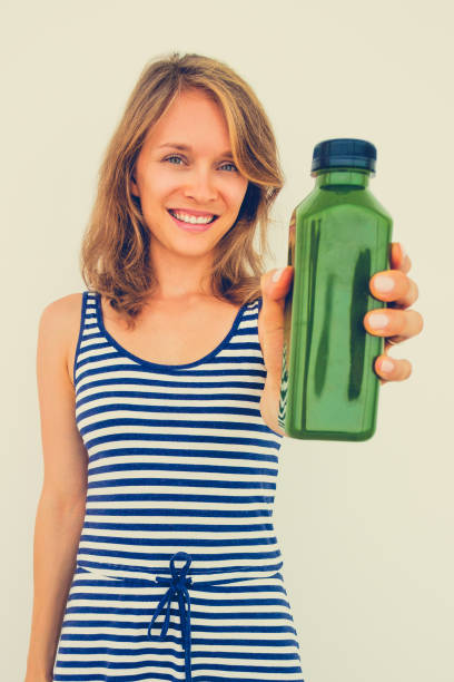 istock Positive young woman showing good item 864926594