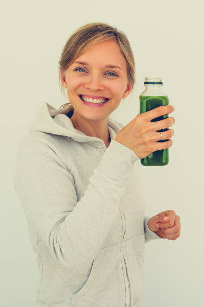 istock Satisfied healthy woman drinking smoothie 864926596