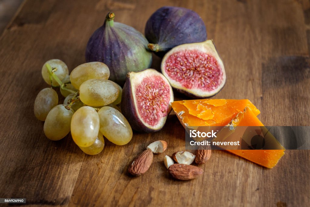 Figs on a table Ripe figs on a wooden table Mimolette Stock Photo
