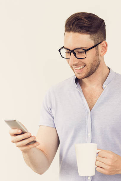 istock Cheerful intelligent man reading message on phone 864929234