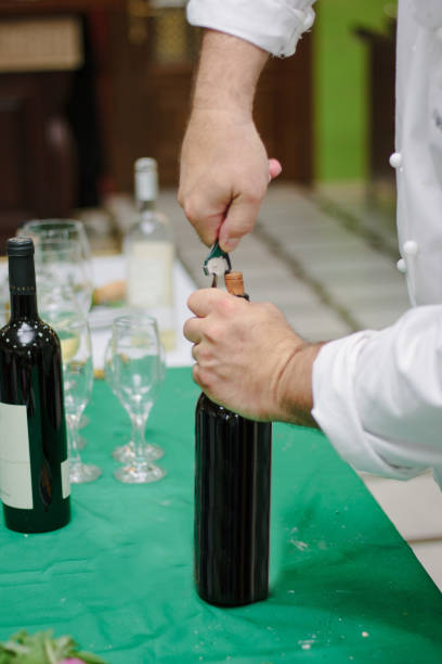 istock Sommelier opens the bottle with red wine. 864936192