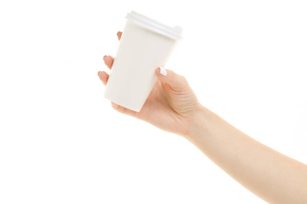 istock Female hands holding coffee in a cardboard glass 864937480