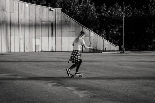istock Hipster girl riding skate board 864943468