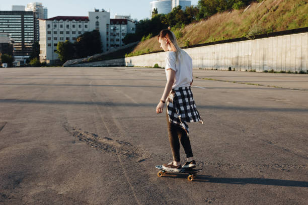 istock Hipster girl riding skate board 864943656
