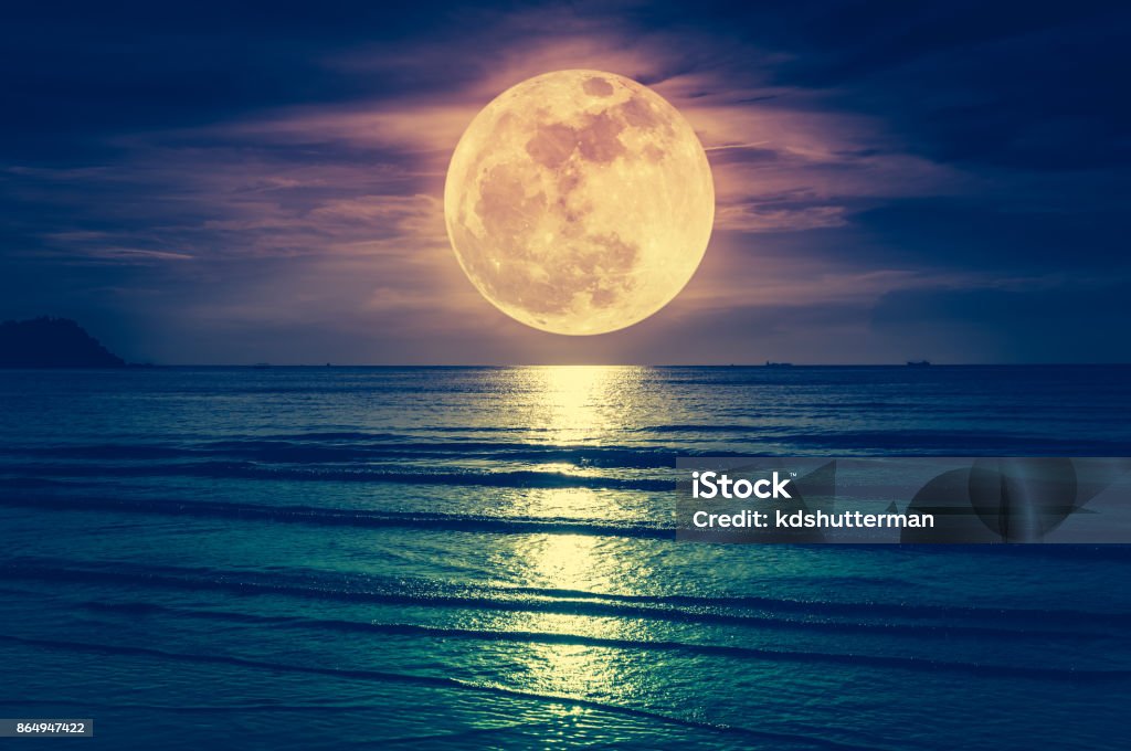 Super moon. Colorful sky with cloud and bright full moon over seascape. Super moon. Colorful sky with cloud and bright full moon over seascape in the evening. Serenity nature background, outdoor at nighttime. Cross process. The moon taken with my own camera. Full Moon Stock Photo