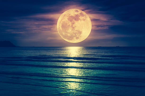 Super moon. Colorful sky with cloud and bright full moon over seascape. stock photo
