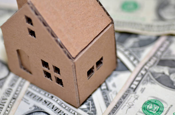 istock Paper made house stands on dollar money 864947544