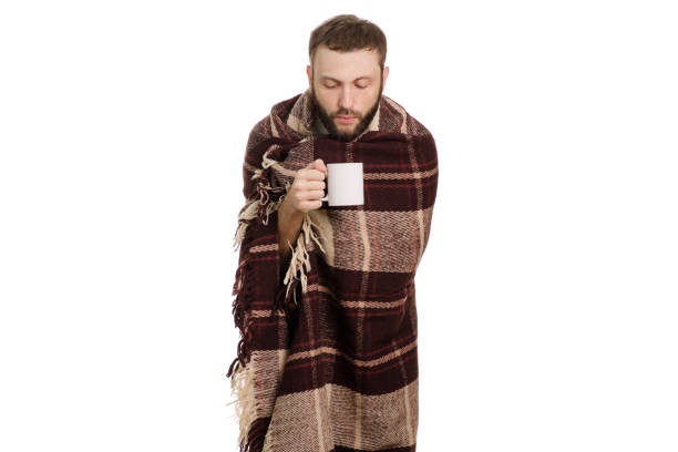 istock A man in a blanket is sick 864950766