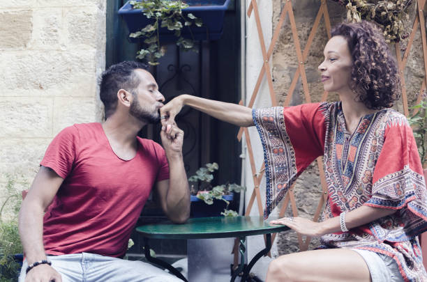 Man kissing woman hand Beautiful hipster breaded man kissing female hand in restaurant. Happy moment. Love concept. indian couple kiss stock pictures, royalty-free photos & images