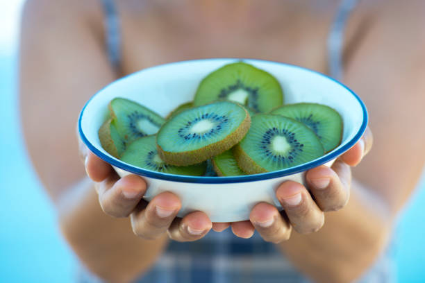 istock Woman Holding Kiwi 864966022