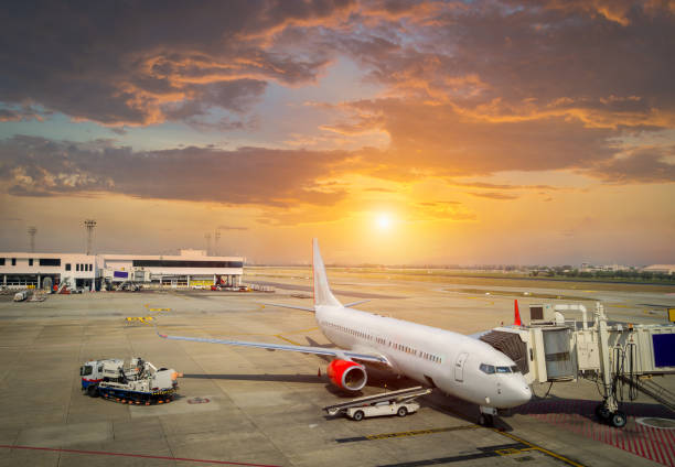 istock airplane ready for boarding in a airport hub at sunset 864969562