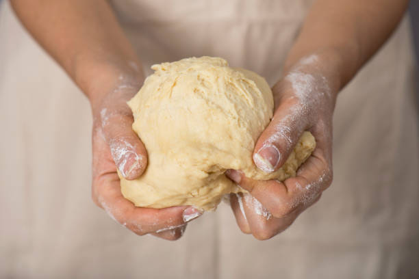 istock Woman holding dough 864969600