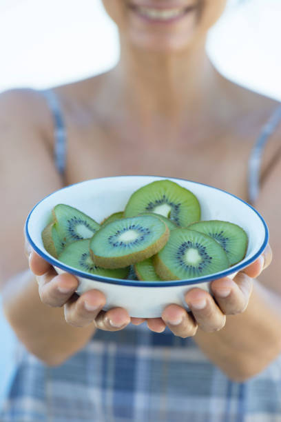 istock Woman Holding Kiwi 864969878
