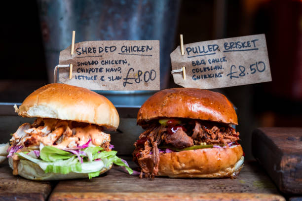 Freshly flame grilled burgers displayed in a row at Borough Market, London