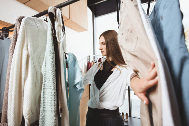 istock girl choosing clothes in boutique 864983898