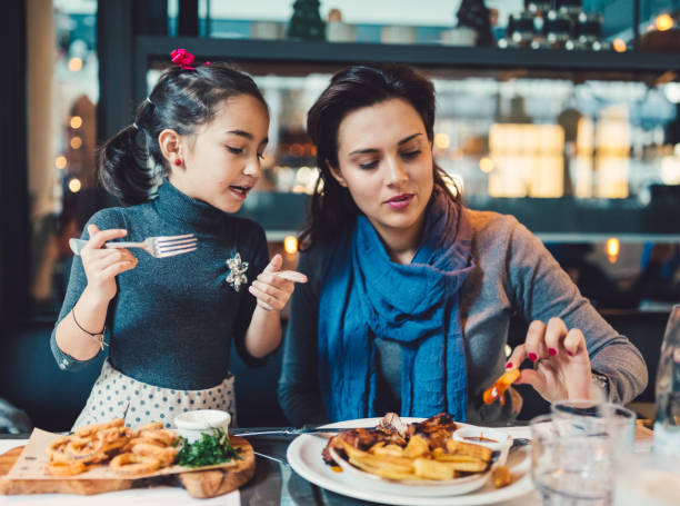 Mother and daughter at restaurant
