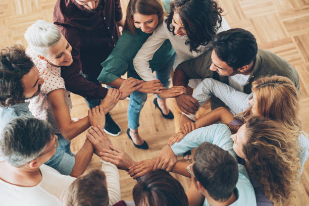 istock Large group of people connecting hands 864984770