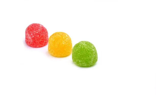 Red, yellow and green jellybean candy isolated on white background