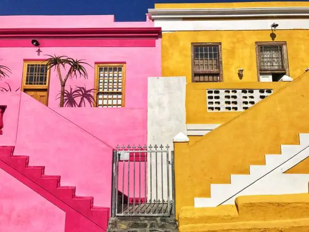 Bo - Kaap is a colorful neighborhood and a center of Malay culture in the city of Cape Town. Houses are painted in bright colors like lime green, lemon yellow, sky blue and vivid pink .