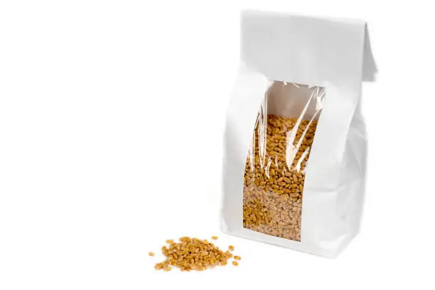 wheat grain in white paper package, healthy organic food