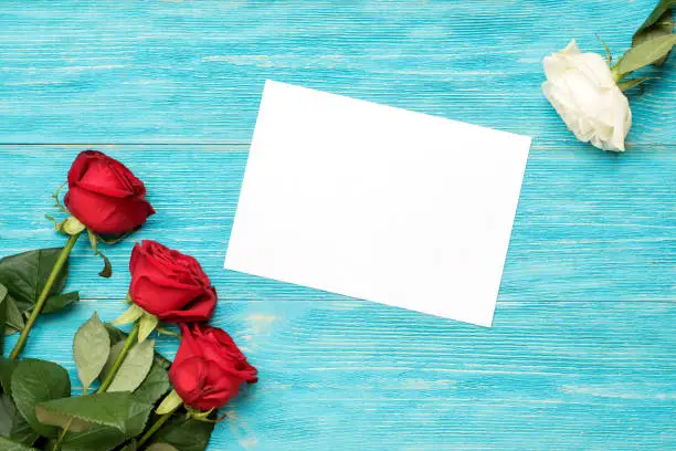 red and white roses with empty paper card