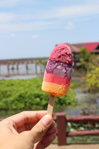 istock Holding popsicle in the hand outdoor 865010196
