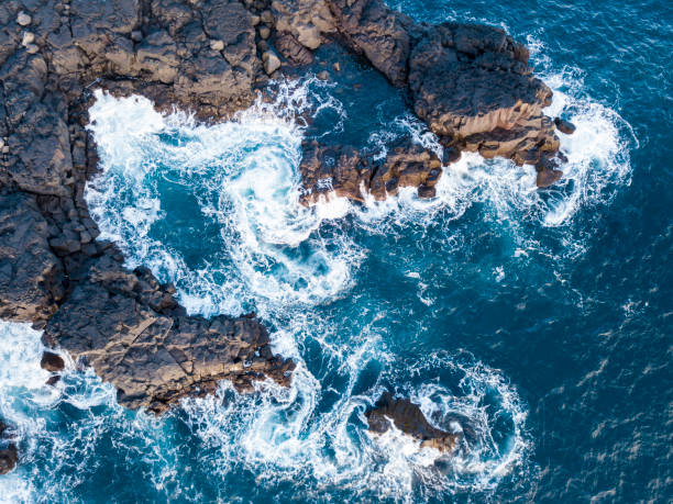 Waves splashing against volcanic rocks