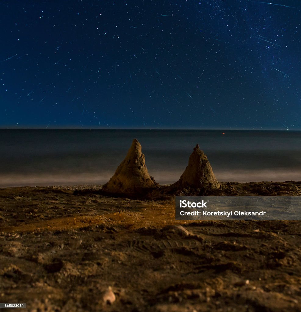 Slides in the sand on the shore of the battlefield under the starry night sky Slides in the sand on the shore the battlefield under the starry night sky Abstract Stock Photo