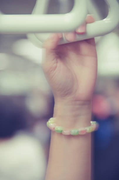 istock Woman's hand holding to the strap in a moving subway train. 865023336