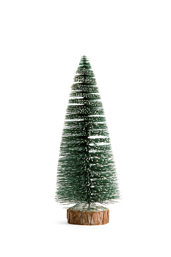 Isolated full artifical christmas tree on a white background. Minimal still life photography