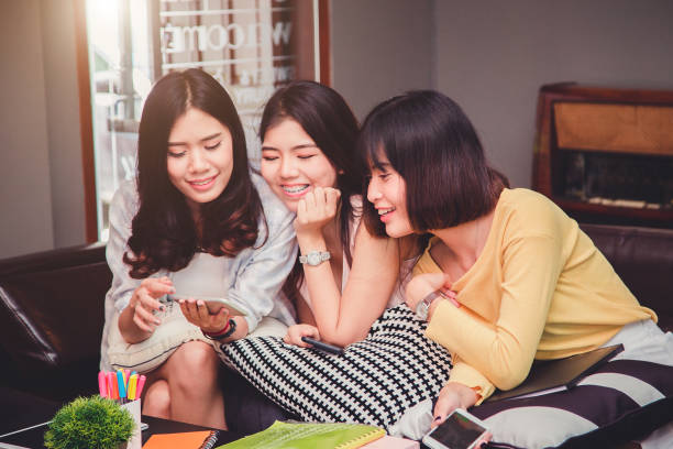 istock Group of young euphoric students.Happy young university students studying with books in library. 865029744
