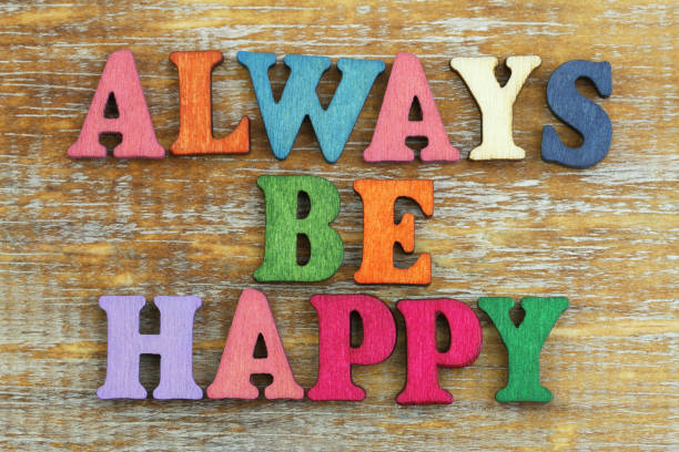 istock Always be happy written with colorful wooden letters on rustic surface 865029854