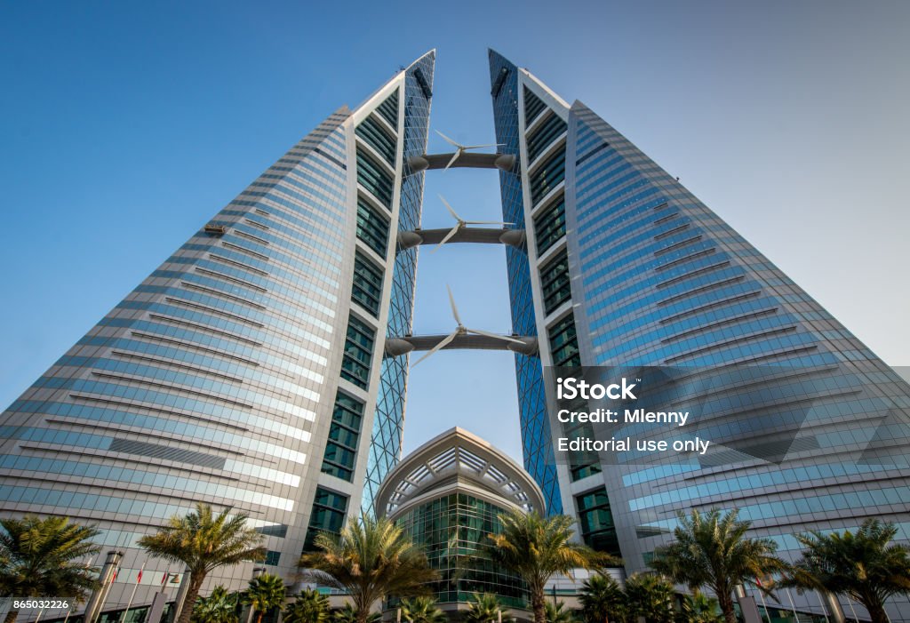 Bahrain WTC World Trade Center Building Manama Manama, Bahrain - 23rd December 2015: Streetview to the modern Bahrain World Trade Center. The well-known WTC Bahrain produces it`s electrical power with built-in wind turbines. Manama, Bahrain, Middle East Sustainable Energy Stock Photo