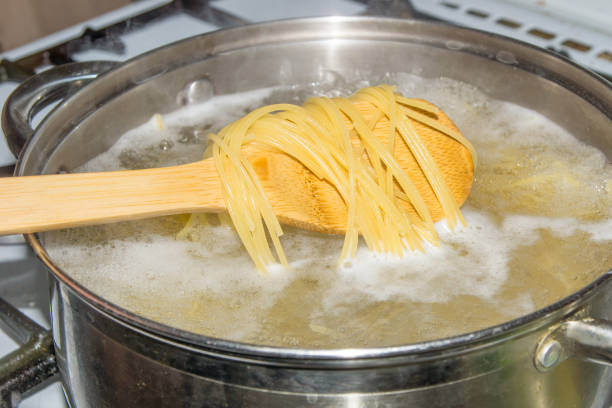 istock Spaghetti cooked in boiling water on a gas stove. 865036114