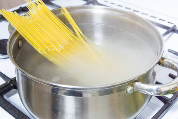 istock Spaghetti cooked in boiling water on a gas stove. 865036194