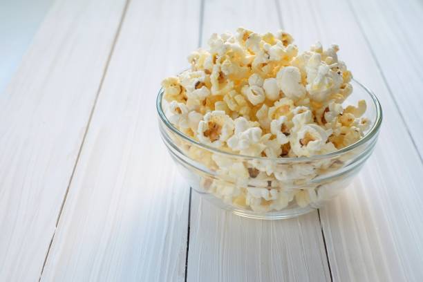 istock popcorn in glass bowl on wooden background 865036276