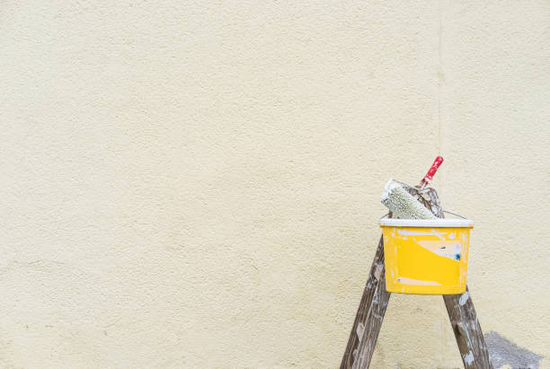 istock Home improvement, ladder with bucket and paint roller in front of white wall 865036332