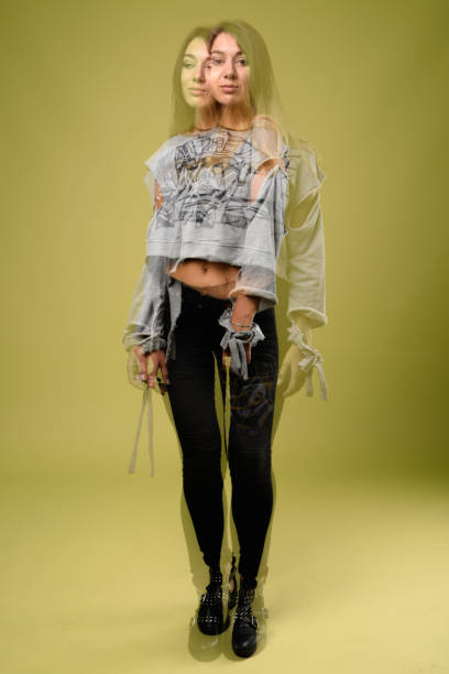 istock Young beautiful rebellious woman against green background 865042212