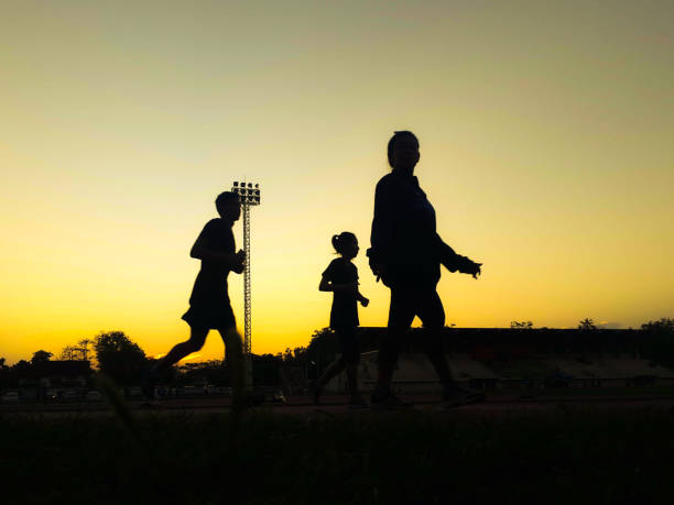 istock Silhouette teen age run together  track. 865053022