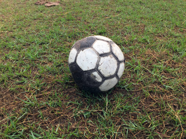 istock Old soccer ball placed on the field. 865059032