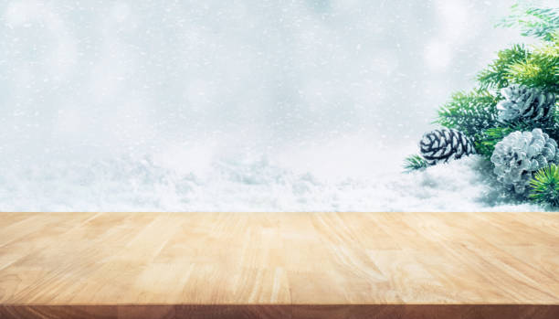 istock Wooden table on fir tree,pine cones,snowfall.Christmas ornament 865059864