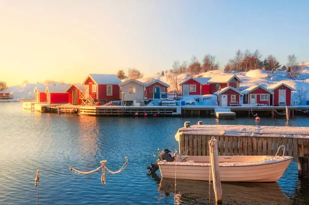 Moored boat in morning sunlight. Winter at the Swedish coastline.