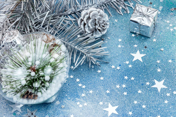 istock christmas tree decorations on blue glitter background with star confetti 865063178